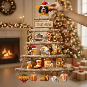 A rustic wooden wall tree decorated with tennessee volunteers themed ornaments and warm glowing lights in a festive living room!