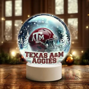 Texas A&M Aggies LED Snow Globe Night Light Christmas Ornament 6 Snow globe style display featuring a Texas A M Aggies helmet on a white base in a winter scene!