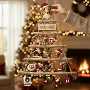 A rustic wooden wall tree decorated with texas am aggies themed ornaments and warm glowing lights in a festive living room!