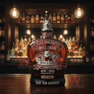 A Texas AM Aggies themed whiskey bottle with a sculpted stopper placed on a bar counter with blurred bottles and lights behind it!