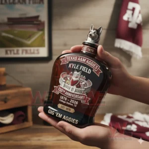 Texas A&M Aggies Kyle Field 150Th Anniversary Gig 'Em Aggies Whiskey Bottle 4 Hands presenting a Texas AM Aggies inspired whiskey bottle indoors with sports themed decorations visible behind!