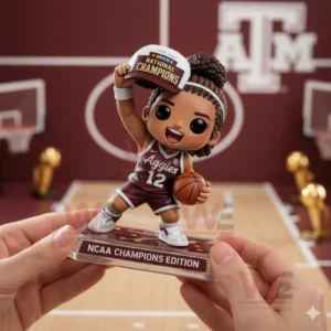 Hands holding a Texas AM Aggies women basketball collectible figure raising a national champions cap and holding a basketball on an NCAA champions edition base with a maroon court background.