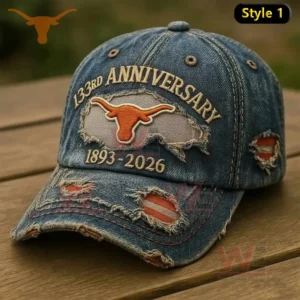 Distressed blue denim baseball cap with embroidered Texas Longhorns logo anniversary design and vintage worn details displayed on a wooden background!