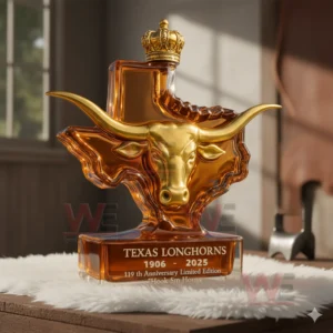 Texas Longhorns 1906-2025 119th Anniversary Custom Whiskey Bottle 4 Texas Longhorns bottle with golden longhorn head and crown top placed on a white rug in soft warm lighting!