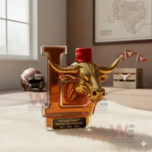 Amber letter L bottle with golden longhorn head and red top standing on a white rug in a bright room with sports decorations!
