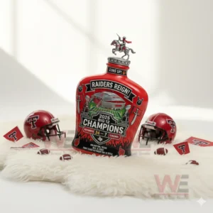 Red sports themed decorative bottle centered on a white fur surface with football helmets and small footballs arranged around it!