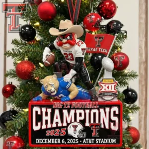 A Christmas tree ornament of the Texas Tech mascot with a football and flag standing over a cougar figure beside the Big Twelve trophy amid team colored decorations!
