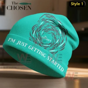 A teal knit beanie displaying a circular pattern and inspiring text across the folded brim!