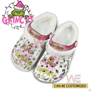 Fleece lined clogs shown with pink straps white exterior and festive character illustrations across the surface!