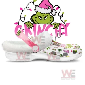 Clogs viewed from the side showing white fleece lining pink adjustable strap and bright character motifs!