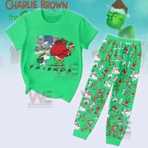 Green Christmas pajama set with a short sleeve shirt showing a winter night village scene and two holiday characters walking together plus matching pants covered in repeating festive illustrations!