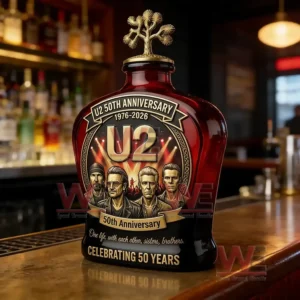 Anniversary style whiskey bottle with illustrated band members positioned on a bar counter in a warmly lit lounge!