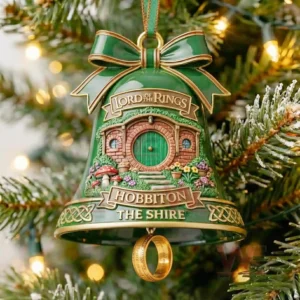 Green bell ornament with a sculpted Hobbit house scene and a golden ring hanging underneath representing the Shire from the Lord of the Rings!