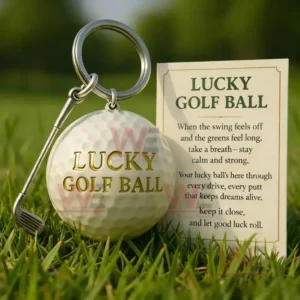 Golf ball keychain displayed on green grass next to a motivational card about luck and confidence in golf!