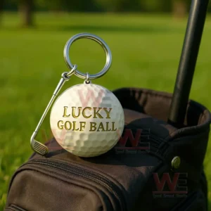 The Lucky Golf Ball Keychain 6 Golf ball keychain attached to a golf bag with green fairway in the background!