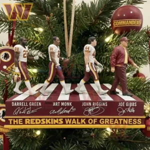 Four Redskins themed figures walk in sequence on a display base with a Christmas tree filled with burgundy and gold decorations in the background!