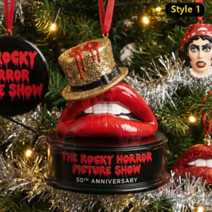 The image displays a Rocky Horror themed ornament with red lips and a gold hat hanging on a decorated Christmas tree.