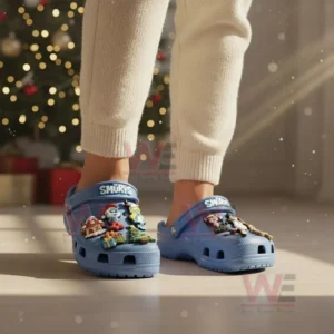 Person wearing light blue Smurfs clogs with festive charms in a holiday room!