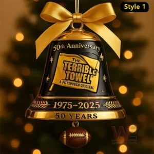 A black and gold Terrible Towel fiftieth anniversary bell ornament with a golden bow and football charm hanging against a blurred Christmas tree background!