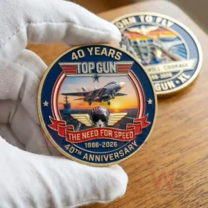 Close up of a Top Gun commemorative coin held in a white glove on a wooden table!