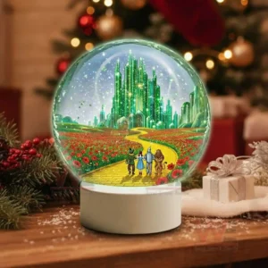 A snow globe showing four travelers on a yellow brick road leading to a glowing emerald city surrounded by red flower fields!