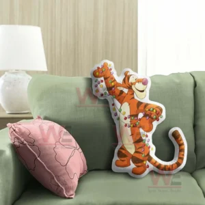 Tiger christmas pillow with string lights displayed on a green sofa in a warm living room!