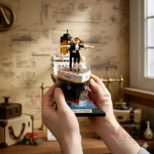 Hands holding a small building block Titanic ship model with a couple standing at the front in a themed room!