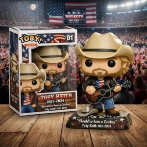 A vinyl style country musician figure with a cowboy hat and guitar standing on a base beside a display box with a stadium crowd background!