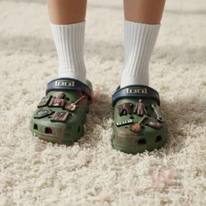 Tool Band Crocs Crocband Clogs With Charms 4 Person wearing green Tool themed clogs with blue straps and anatomical guitar and eye charms while standing on a carpet!