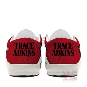 Rear view of paired red slip on shoes with Trace Adkins printed in large black letters on both heels!