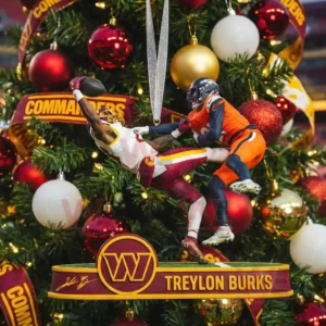 A Christmas tree ornament displays two football players mid jump as one makes an extended catch in front of festive decorations!