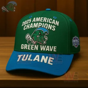 Green and blue Tulane Green Wave 2025 American Champions cap with raised lettering and mascot logo on a wooden table.