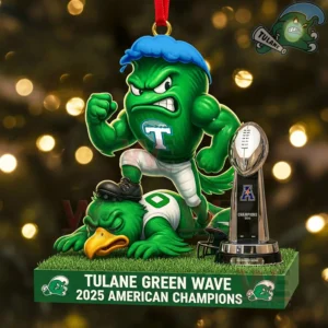Ornament of Tulane Green Wave mascot standing over defeated opponent with American championship trophy in front of a lit Christmas tree.
