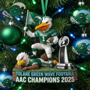 A Christmas tree ornament of the Tulane mascot holding a flag and football standing over an eagle figure with the AAC trophy nearby among green and blue decorations!