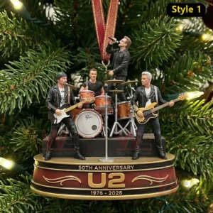 The image displays a miniature band performing on a small anniversary stage hanging on a Christmas tree.