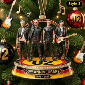 The image displays a four member band standing on a decorative anniversary stage among festive tree ornaments.