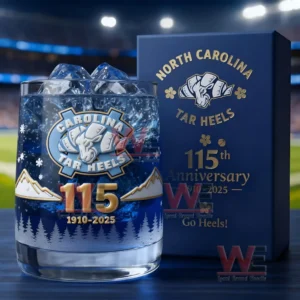 Carolina Tar Heels themed glass with ice and clear drink next to a blue anniversary box inside a stadium environment!