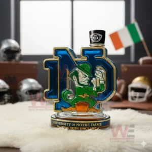 An ND emblem bottle with a black cap standing on a white fuzzy mat with sports equipment and an Irish flag behind it!