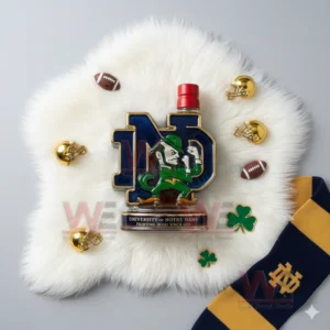 An ND emblem bottle with a red top placed on a white furry mat surrounded by small helmets footballs shamrocks and a Notre Dame scarf!
