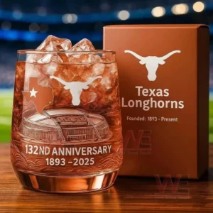 A Texas Longhorns anniversary whiskey glass with ice logo engraving and presentation box shown in a sports themed setting!
