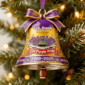Gold and purple bell ornament featuring U S Bank Stadium with snowy details a Purple Pride banner and a dangling football marking years nineteen sixty to twenty twenty five!