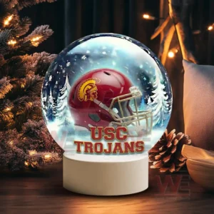 Illuminated glass sphere with USC Trojans helmet against a snowy background on a white base!