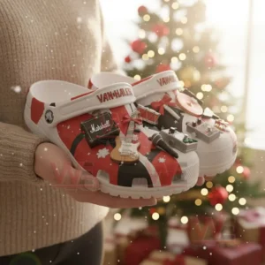 Van Halen Christmas Crocs Clogs with Charms 4 Hands holding Van Halen themed clogs decorated with musical charms near a Christmas tree.