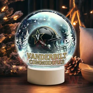 Illuminated glass sphere with Vanderbilt Commodores helmet against a snowy background on a white base!