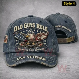 Two distressed denim caps showing Old Guys Rule USA Veteran embroidery with a large eagle patriotic emblem on the front cap and Real Heroes Wear Capes text on the back cap.