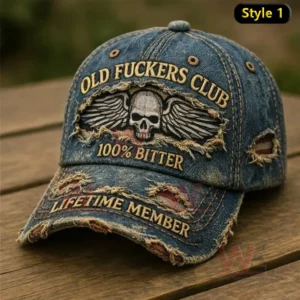 Distressed denim baseball cap with skull and wings embroidery displayed on a wooden table!