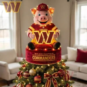 A pig mascot in Washington Commanders gear sits on the tree top holding an illuminated W with holiday lights and ornaments below.