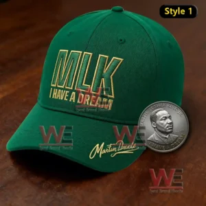 Green memorial cap with embroidered dream message placed on a wooden surface with a tribute coin nearby!