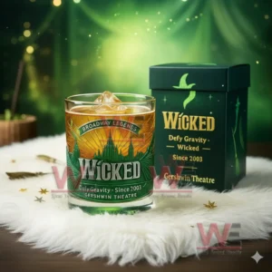 A Wicked themed ice filled glass next to a green decorative box with a glowing green backdrop!