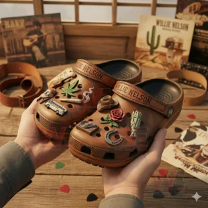 Brown themed country clogs with multiple music and lifestyle charms held by hands against a warm wooden background!